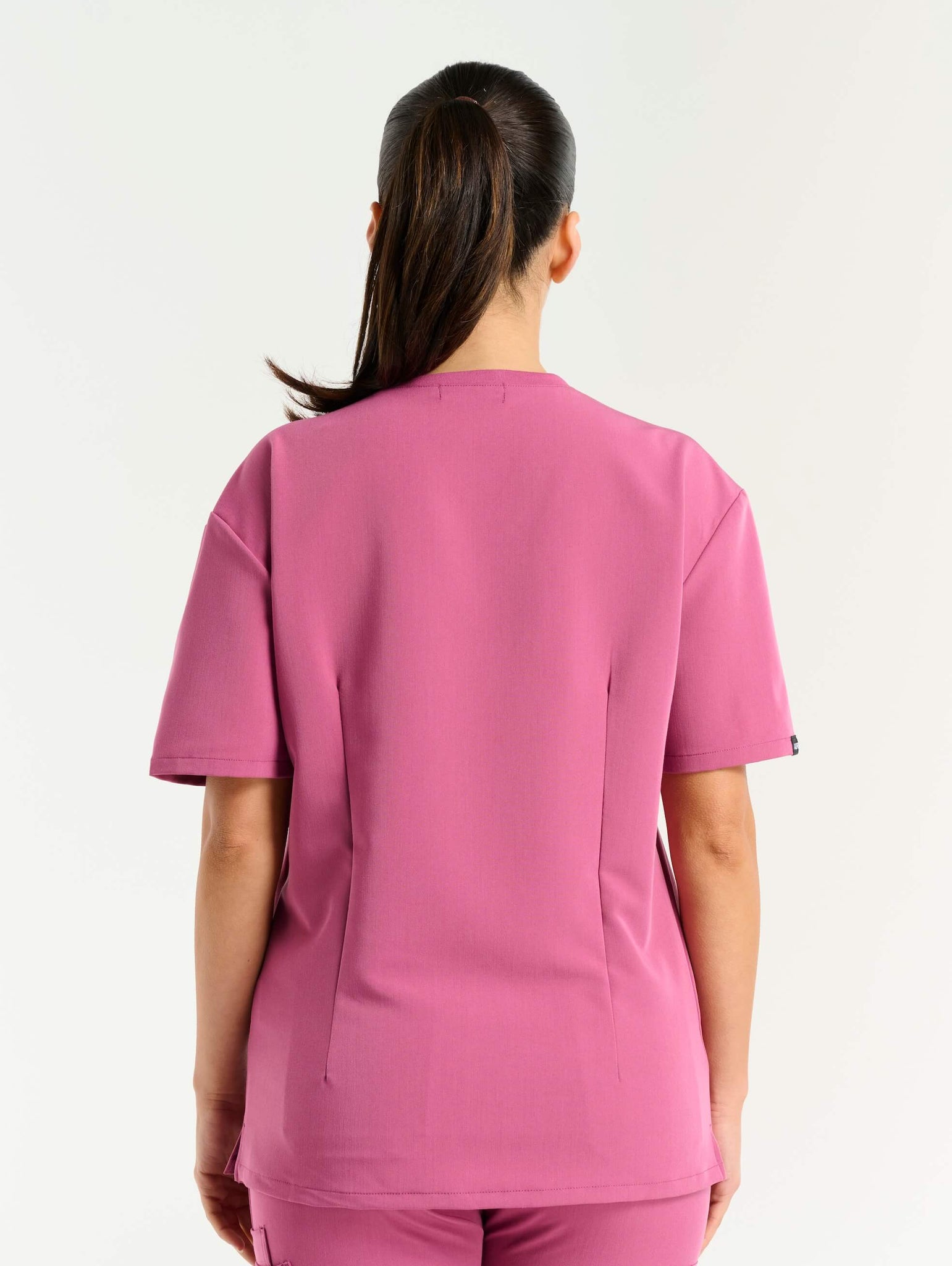 full body view of red violet v neck scrub top